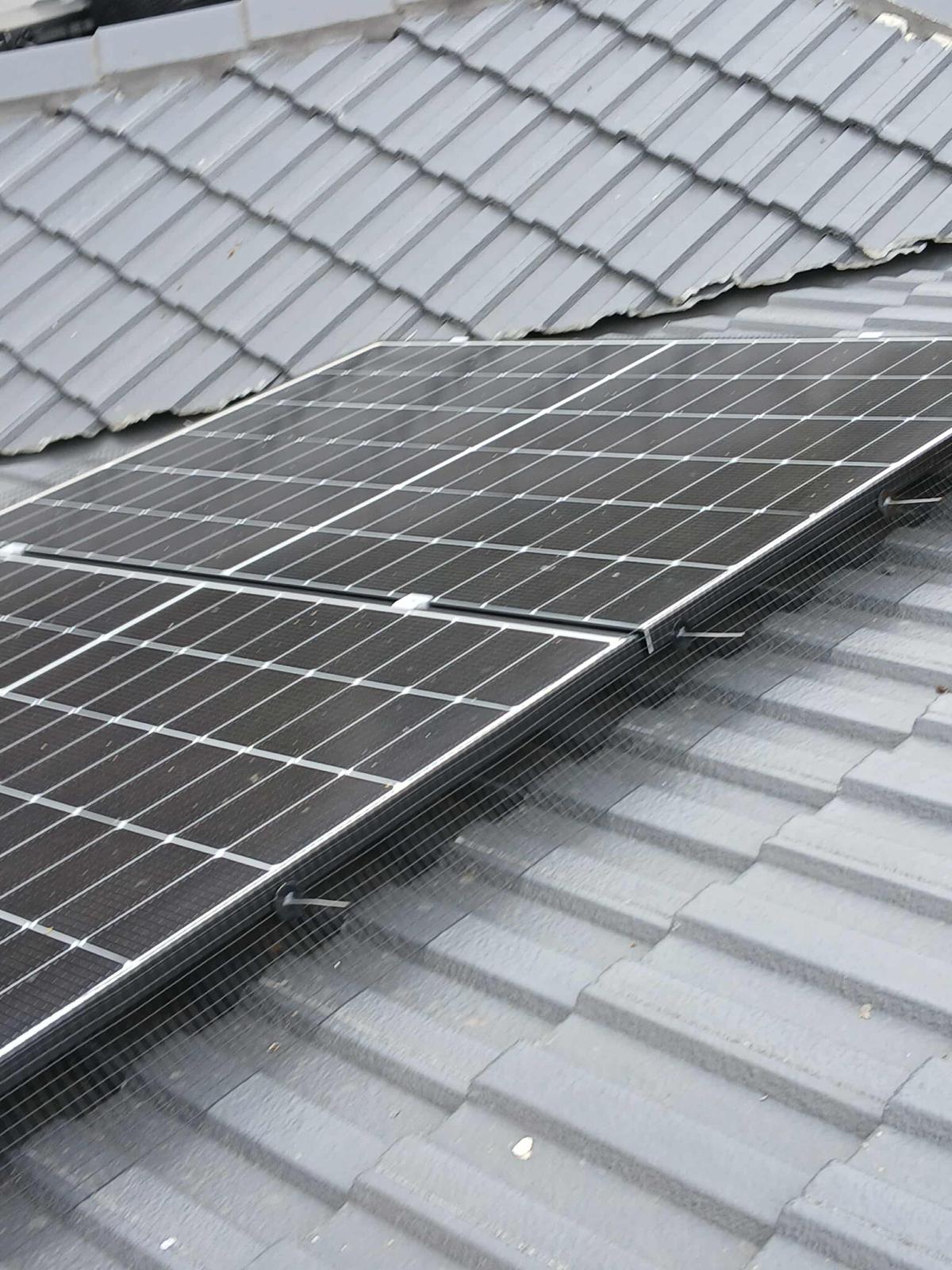 Bird proofing mesh installed under solar panels on a tiled roof in Adelaide by Symes SA